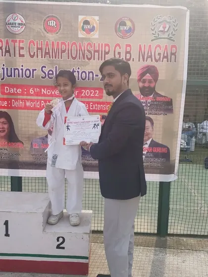 Samaira Keshari receives her silver medal at the District Karate Championship.
