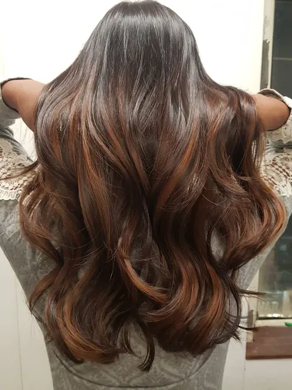 Here is a beautiful example of my seamless balayage work on long, dark hair. I hand-painted caramel and honey tones to create a natural, sun-kissed effect that adds incredible depth and movement, styled into classic soft curls.
