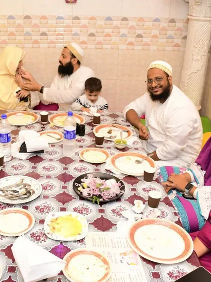 A happy family enjoying their meal. Our dastarkhwan setup is family-friendly, allowing everyone from the youngest to the oldest to dine together comfortably.