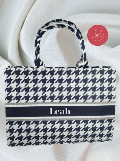 A mini version of our popular tote bags, this one in a classic houndstooth print. It's personalised with the name 'Leah' and is perfect for carrying smaller essentials.