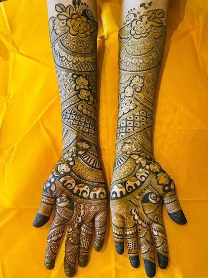 Another view of the intricate bridal mehendi with elephant bands and floral patterns, showcasing the full length of the design.
