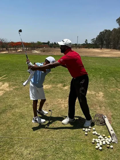 A hands-on adjustment for a young player. Building the right habits from the start is crucial for long-term success.