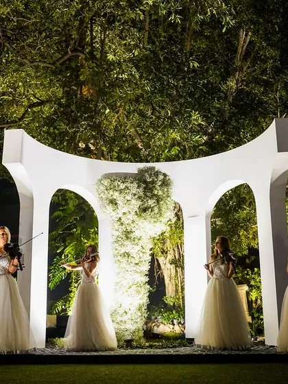 Live entertainment set against a custom-designed white architectural backdrop. The stage was framed with a wall of white flowers, integrating the performance into the overall decor.