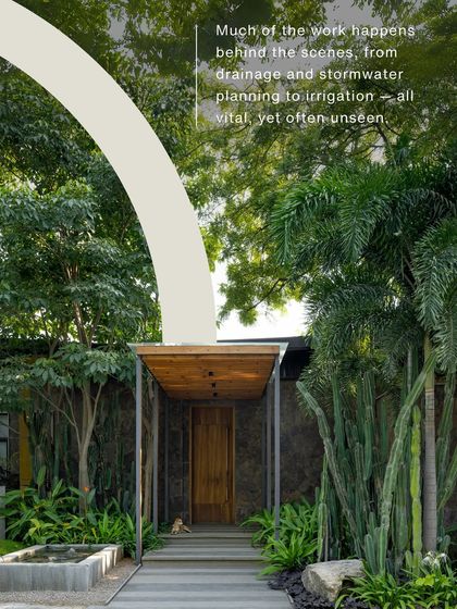 A view of a beautifully designed entrance, with text explaining the unseen work of drainage and stormwater planning. This educates the client on the technical aspects of landscape architecture.