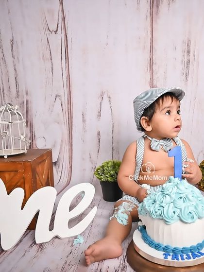 The aftermath of a successful cake smash. With a little frosting on his leg, this little guy is enjoying the spoils of his first birthday celebration.