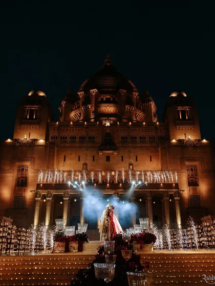 A truly cinematic moment as the couple takes the stage at the magnificent Umaid Bhawan Palace. We specialize in creating these larger-than-life, epic moments that feel like they're straight out of a movie.