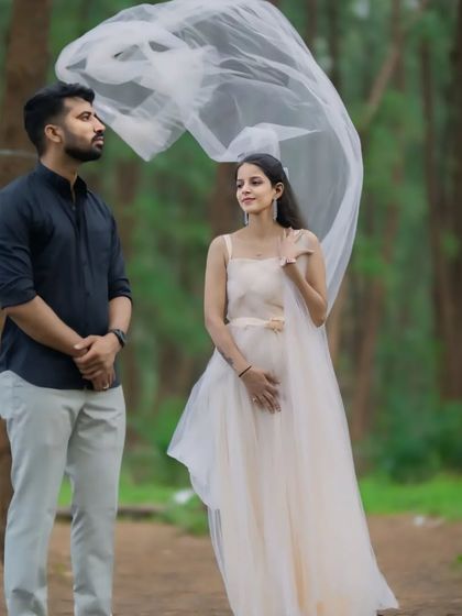 This couple's portrait in the woods has a magical feel, thanks to the flowing fabric of our off-white gown. We provide outfits that help tell your unique love story.