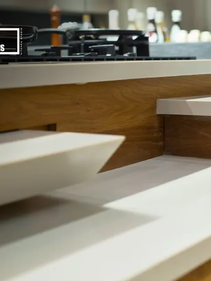 A close-up of a multi-level countertop, an innovative design feature that adds dimension and separates work zones within the kitchen.