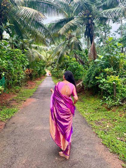 A personal moment from my trip to Malnad. I'm wearing a vibrant purple Kanchivaram with a simple pink blouse, enjoying the beautiful scenery.