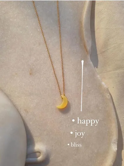 My yellow opal Luna pendant, a stone I chose for its joyful energy. It's a charm for happiness, bliss, and creativity in relationships.