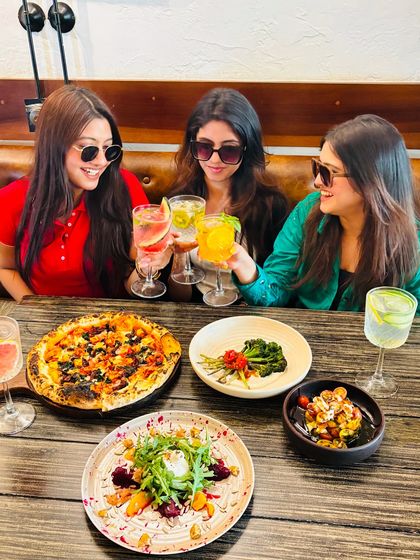 Another shot of the girls enjoying their time. The smiles say it all. Good food brings people together.