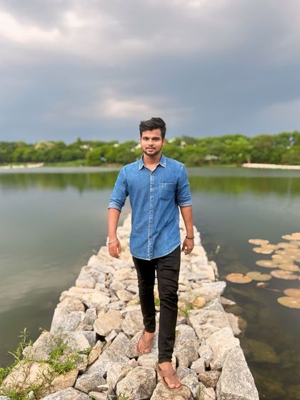 The cloudy sky adds a dramatic touch to the peaceful lake scenery.