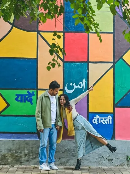 We love incorporating vibrant, modern backdrops into our pre-wedding shoots. This colorful mural adds a playful and artistic energy to the couple's portraits, showing their fun side.