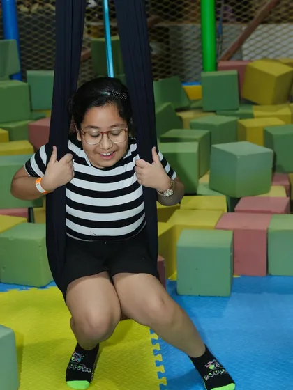 Taking a swing in our foam pit, a safe and fun spot for kids to practice their acrobatic moves.