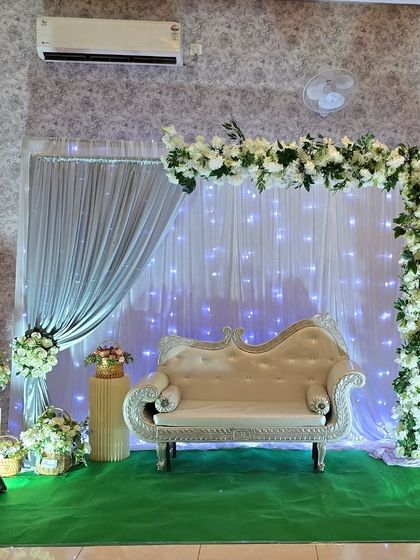 Another view of the elegant white floral stage setup, suitable for engagements, receptions, or anniversary parties.