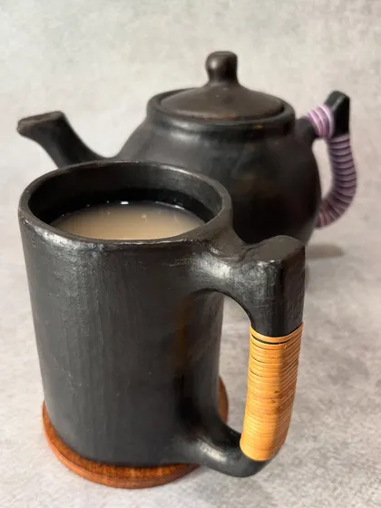 Our traditional Naga rice drink, Zutho, served in a handcrafted Longpi pottery mug and pot. This ancient pottery from Manipur adds a touch of heritage to the experience.