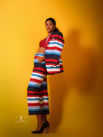 A profile view that emphasizes the clean lines and vibrant pattern of the suit. The negative space in the composition makes the subject stand out.