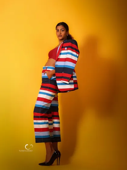 A profile view that emphasizes the clean lines and vibrant pattern of the suit. The negative space in the composition makes the subject stand out.