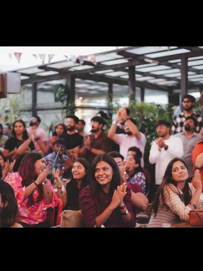 A wide shot of the audience clapping and cheering. The shared experience creates a strong sense of community and togetherness.