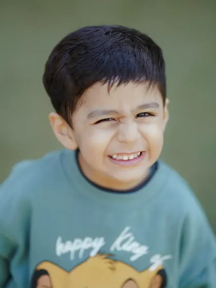 The cheeky, scrunchy-nosed smile of a happy kid. I love capturing these little expressions that show off a child's unique personality during our outdoor sessions.