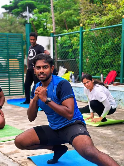 Mobility is key to longevity in running. Here, we are working through a set of dynamic stretches, like this side lunge, to open up the hips and improve range of motion. Every session includes movements like this to keep you flexible.