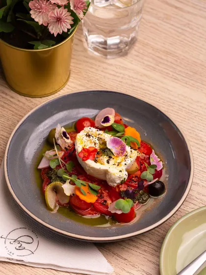 Simplicity at its finest. My Tomato and Burrata salad showcases the beauty of fresh, high-quality ingredients. I pair creamy burrata with juicy, ripe Monterosa tomatoes and edible flowers for a dish that is as beautiful as it is delicious.
