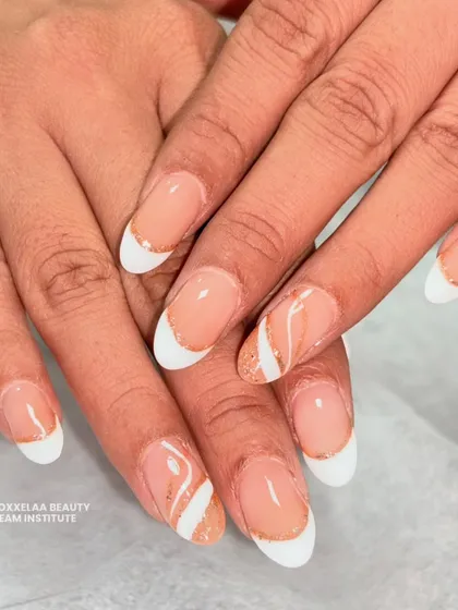 Proving that simple can be stunning. This is my take on the "clean girl" aesthetic, featuring a classic French manicure on almond nails with a delicate swirl of rose gold glitter for a subtle pop.