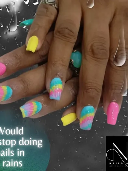 A playful, multi-colored set. This design features a tie-dye effect on some nails, paired with solid neon pink and yellow for a fun, summery look.
