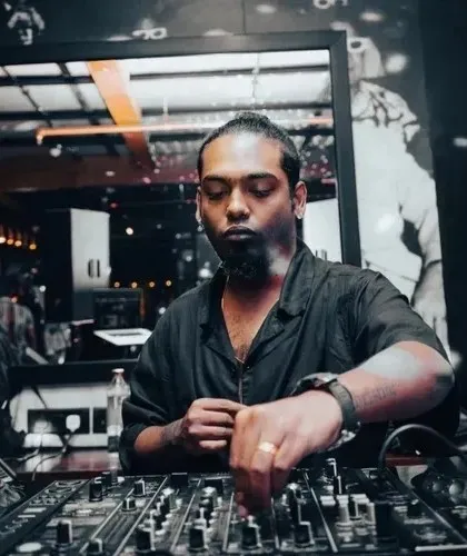 Let the music do the talking. A focused shot of me at the mixer, crafting the sound for the night.