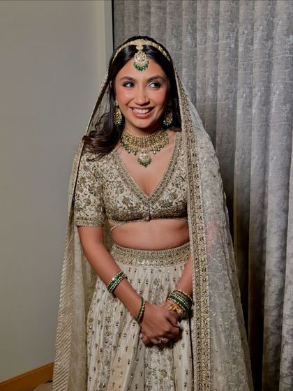 Another shot of the bride, looking happy and serene. The soft makeup and open hairstyle create a look of effortless elegance.