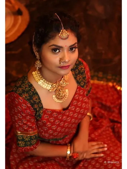 A top-down view creating an intimate and detailed portrait. This angle provides a unique perspective on the traditional jewelry and the model's expressive eyes.
