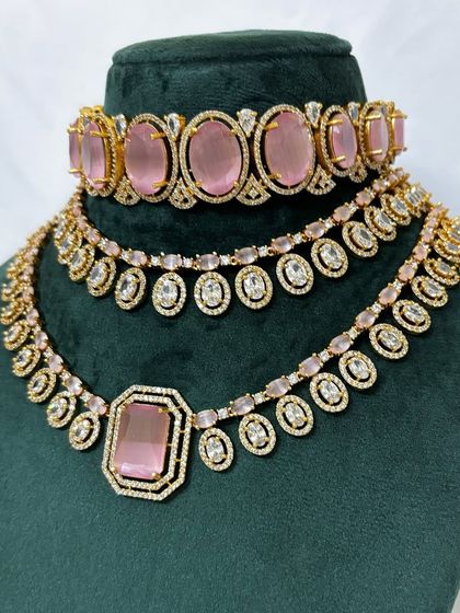 A close-up of the pink stone necklace set. The combination of the choker and necklace creates a full and festive look, available for rent.
