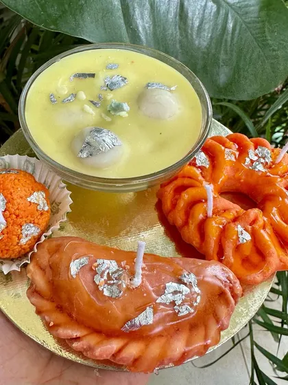 A complete Indian Mithai candle platter featuring Rasmalai, Gujiya, Imarti, and Laddoo candles, a truly unique centerpiece.
