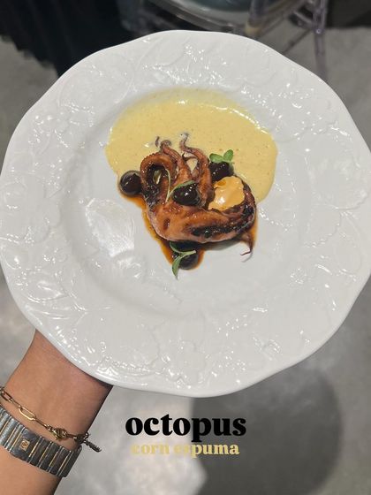A dish from my Mexican-themed supper club: tender octopus served with a corn espuma, showcasing a blend of textures and flavors.