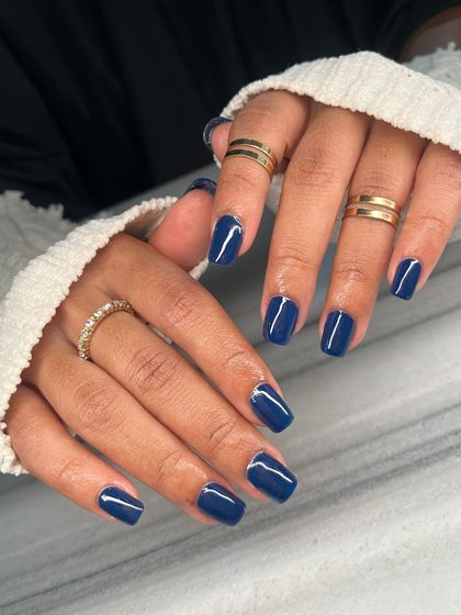 The full view of the stunning navy blue manicure. The high-gloss finish makes the color look rich and luxurious.