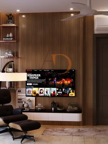 The room includes a comfortable lounge area with an Eames-inspired chair and a sleek, floating TV console, making it a multi-functional retreat.