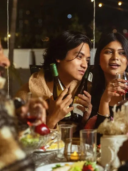 Friends sharing wine and laughter around the dinner table. My goal is to create a comfortable and celebratory atmosphere where guests can connect and enjoy great food together.