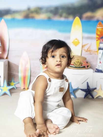 An adorable, curious look from a baby during the beach-themed sitter session.
