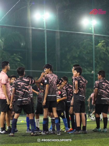 A team huddle during a training session, where players listen to their coach and motivate each other.