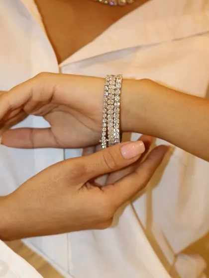 Your wrist, your spotlight. A close-up of a stunning multi-row diamond bracelet being fastened.