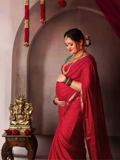 A quiet moment of connection. This beautiful mama-to-be gazes lovingly at her bump, her traditional attire adding a layer of grace and heritage to the portrait.