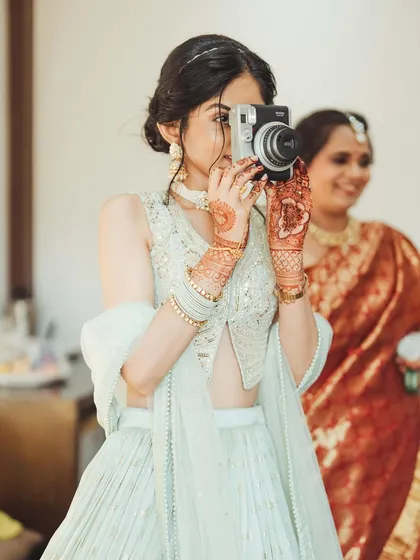 A guest captures a memory on a Polaroid camera, a beautiful meta-moment of memory-making.