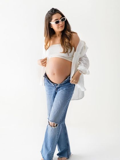 Bringing a little bit of sass and style to the shoot. A pair of sunglasses can add a fun, editorial touch to your casual maternity portraits.