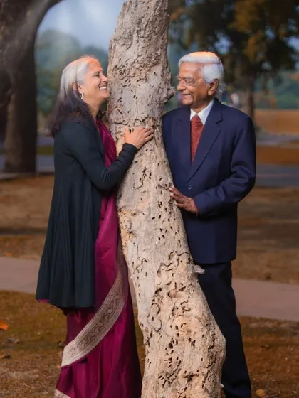 A playful and sweet moment from their 50th-anniversary shoot. Their smiles as they peek at each other from behind a tree show that the spark of romance never fades.