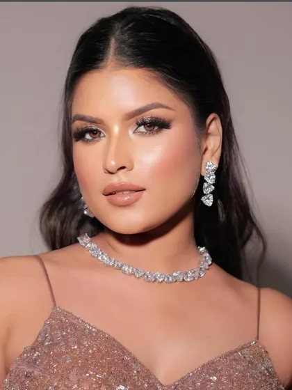 A glamorous look perfect for a cocktail party or reception. The makeup features shimmery eyes, glowing skin, and a glossy nude lip.