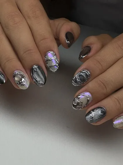 Another shot of the incredible 3D chrome nail art, showcasing the dimension and texture of the sculpted silver elements.
