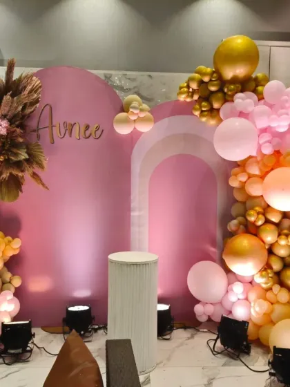 A duplicate image of the pink and gold boho home setup, highlighting the custom name sign and dried pampas grass details.