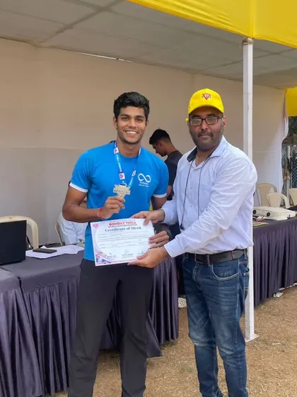 An athlete proudly receiving his medal and certificate after a great performance.
