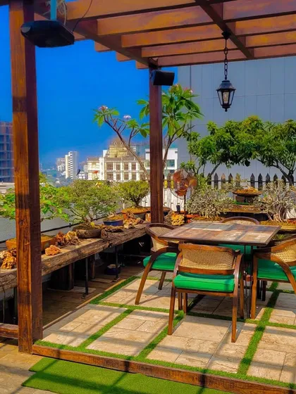 This rooftop terrace offers a stunning view of the city. We designed it with a wooden pergola, rustic bench seating, and an abundance of plants to create a green, vibrant oasis high above the urban landscape.