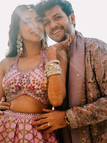 Rupanshi and Yash in a sun-drenched, happy portrait. The lens flare adds a touch of magic to this candid moment of affection.